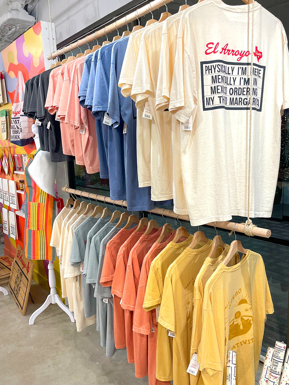 Colorful t-shirts on hangers in a store setting