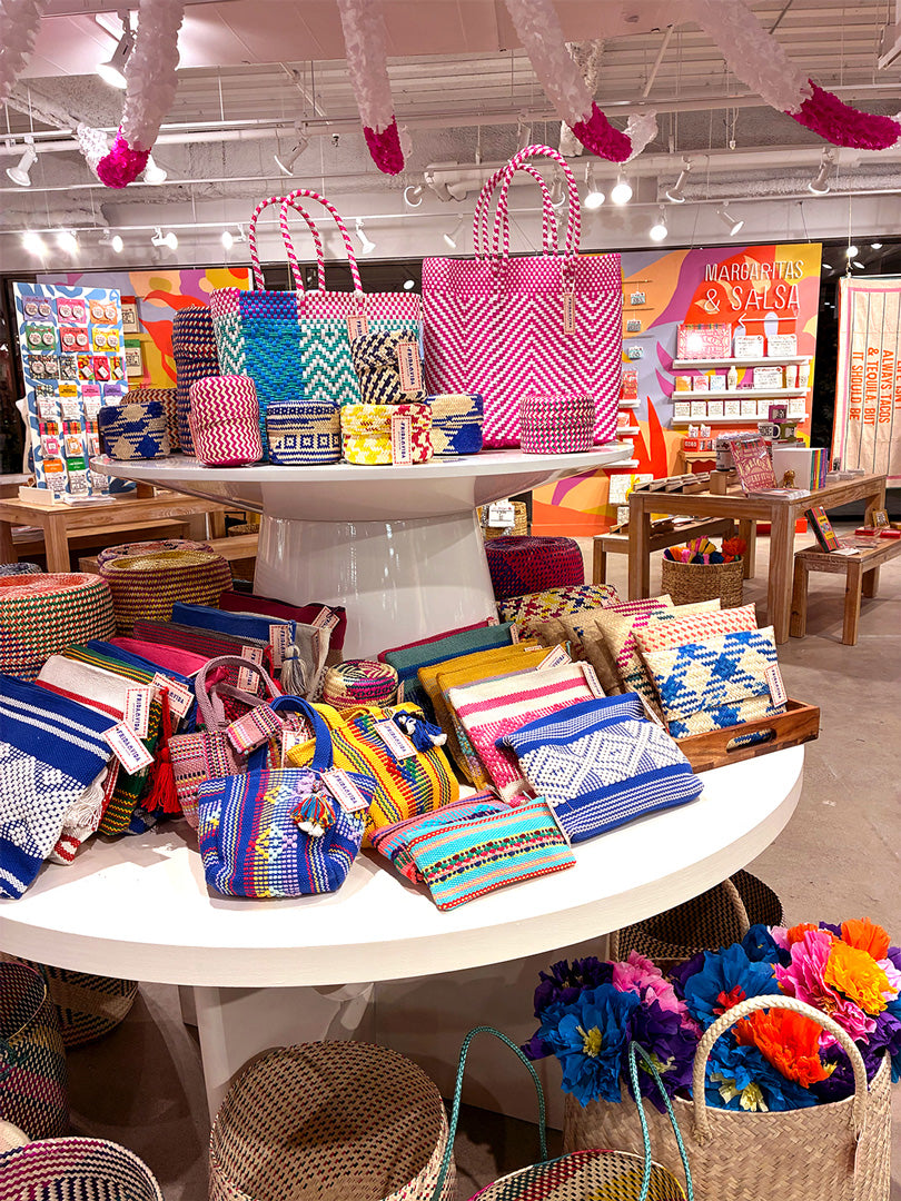 Display of colorful handbags and accessories in a store setting